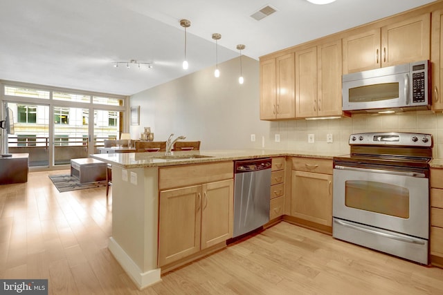 888 N Quincy St Unit 407, Arlington, VA 22203 - kitchen featuring stainless steel appliances, light brown cabinetry, and a sink