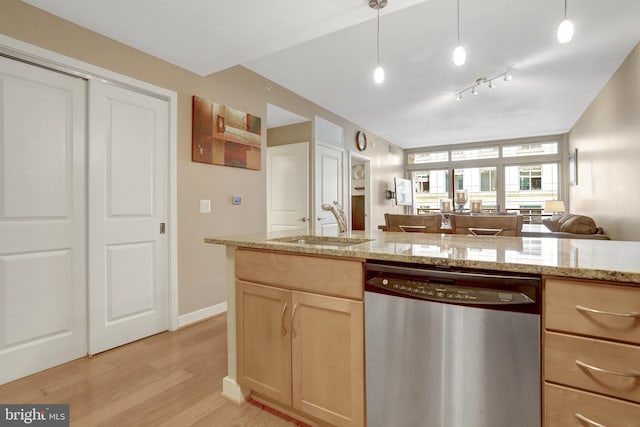 888 N Quincy St Unit 407, Arlington, VA 22203 - kitchen featuring stainless steel dishwasher, a sink, light brown cabinets, light wood-type flooring, and light stone countertops