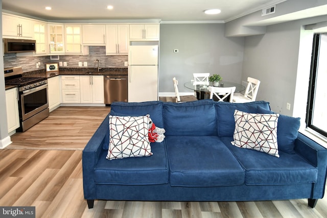 6137 Leesburg Pike Unit 101, Falls Church, VA 22041 - living area featuring ornamental molding, light wood-style floors, baseboards, and recessed lighting