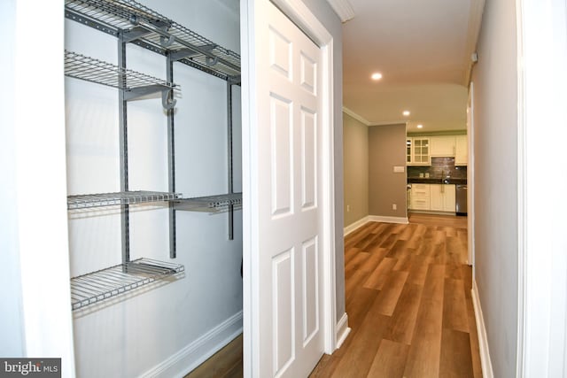6137 Leesburg Pike Unit 101, Falls Church, VA 22041 - hallway with wood finished floors, baseboards, recessed lighting, and crown molding