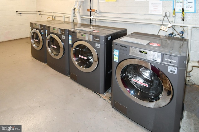 6137 Leesburg Pike Unit 101, Falls Church, VA 22041 - shared laundry room with washing machine and dryer and concrete block wall