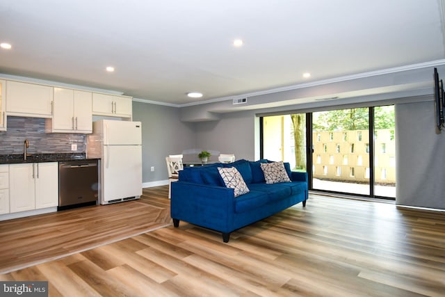 6137 Leesburg Pike Unit 101, Falls Church, VA 22041 - living room featuring crown molding, baseboards, recessed lighting, and light wood-style floors