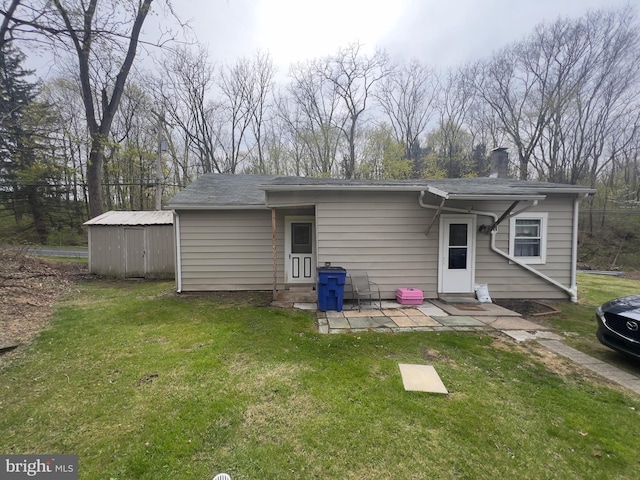 back of property featuring a yard, entry steps, a patio, and a chimney