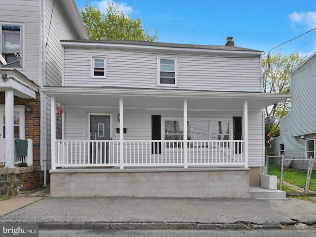 232 N Coal St, Port Carbon, PA 17965 - view of front of home featuring a chimney, covered porch, and fence