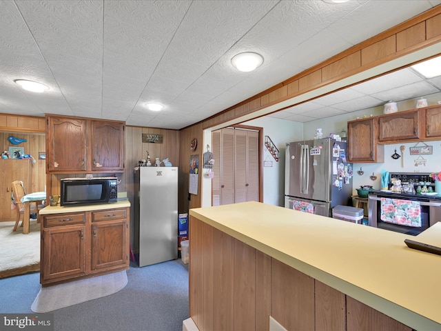 232 N Coal St, Port Carbon, PA 17965 - kitchen with black microwave, light colored carpet, and freestanding refrigerator