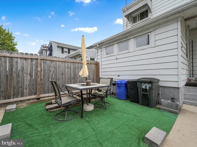 exterior space with outdoor dining area and fence