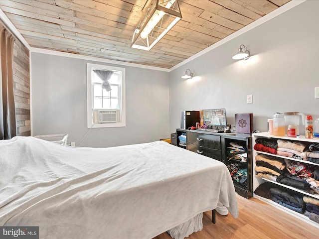bedroom with crown molding, wood ceiling, and wood finished floors