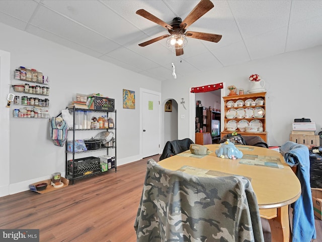 dining area with baseboards, ceiling fan, and wood finished floors