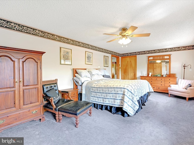 carpeted bedroom with ceiling fan and a textured ceiling
