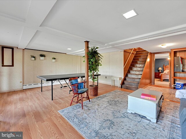 recreation room with wood finished floors and beamed ceiling