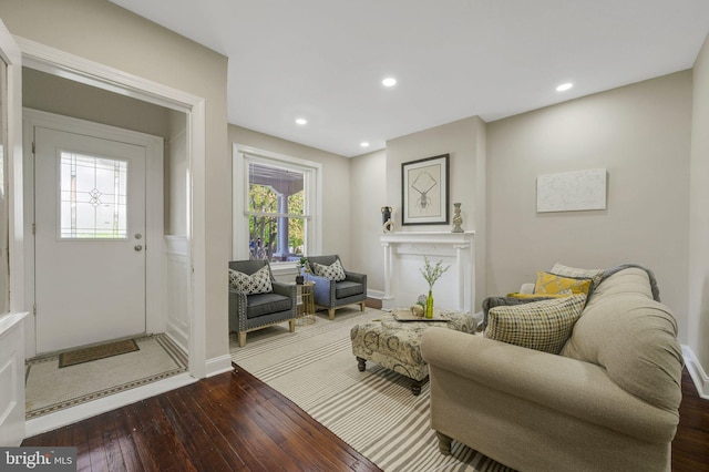 sitting room featuring a fireplace, baseboards, recessed lighting, and wood-type flooring