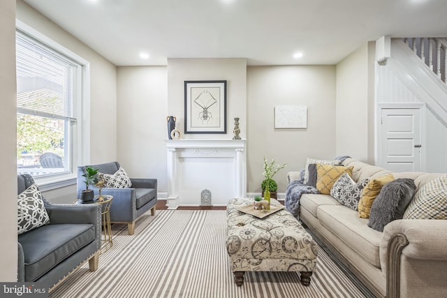living area with recessed lighting, wood finished floors, and baseboards
