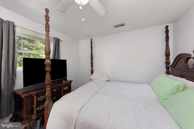 bedroom with lofted ceiling, visible vents, and a ceiling fan