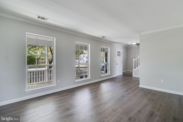 unfurnished room with visible vents, crown molding, baseboards, and stairs