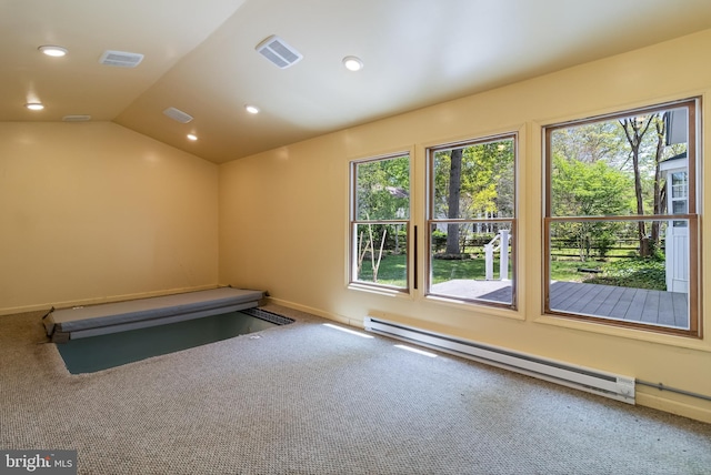 exercise area with baseboard heating, visible vents, carpet, and baseboards