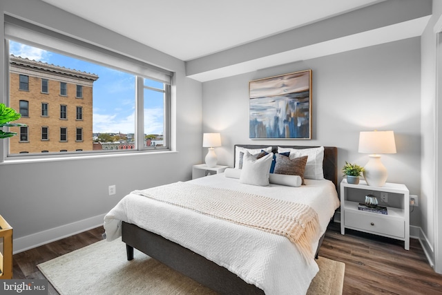 bedroom featuring wood finished floors and baseboards