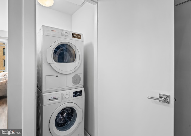 laundry area with stacked washer / drying machine and laundry area