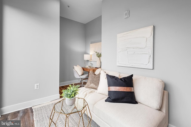 living area featuring wood finished floors and baseboards