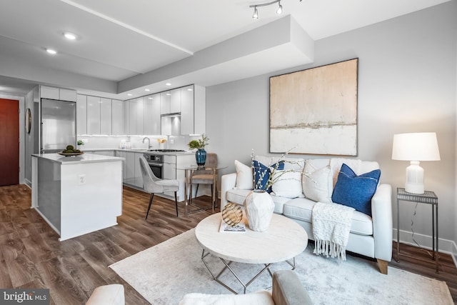living area featuring recessed lighting and dark wood-type flooring