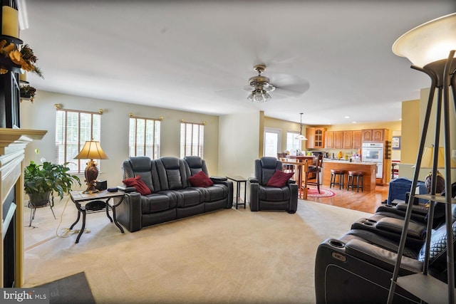 20338 Snowpoint Pl, Ashburn, VA 20147 - living room featuring light colored carpet, a ceiling fan, a fireplace with flush hearth, and recessed lighting