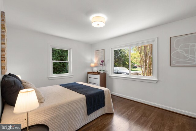bedroom featuring wood finished floors and baseboards