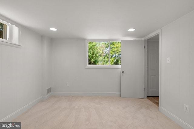interior space with recessed lighting, light carpet, visible vents, and baseboards