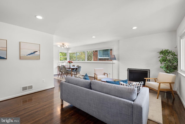 living room with recessed lighting, wood finished floors, visible vents, baseboards, and a fireplace