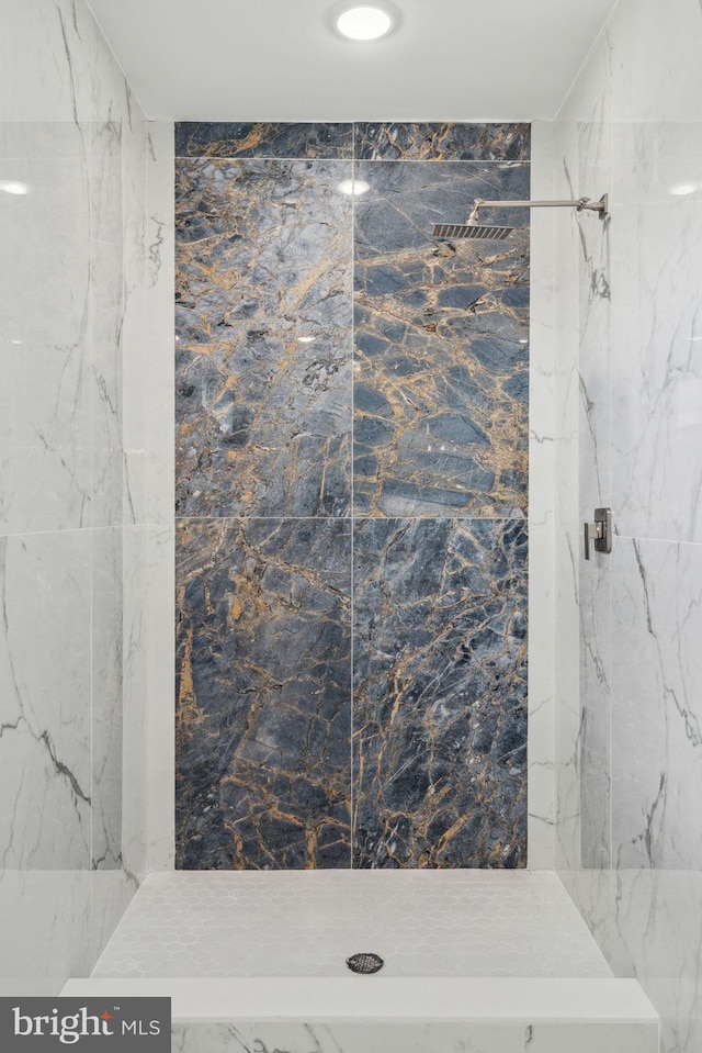 bathroom with a marble finish shower