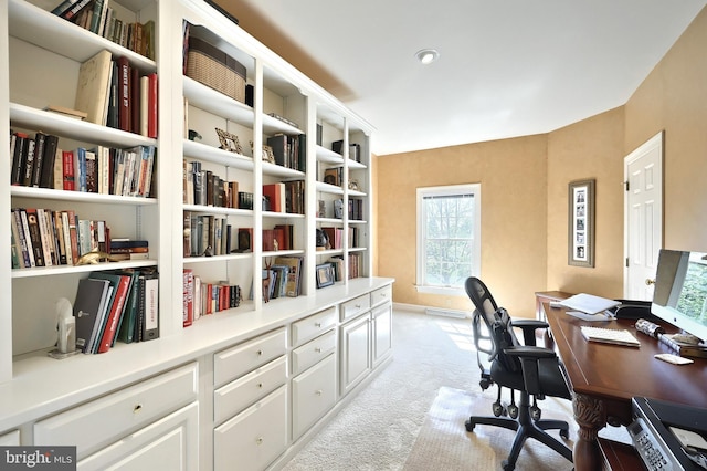 home office with light colored carpet and baseboards