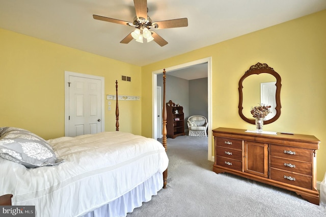 carpeted bedroom featuring visible vents and ceiling fan