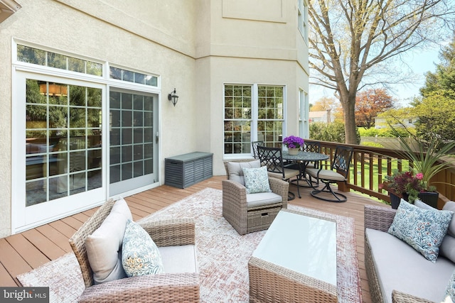 wooden deck with an outdoor hangout area and outdoor dining area