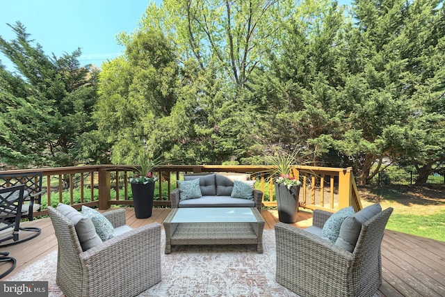 wooden terrace with outdoor lounge area and fence