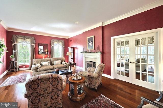 living area with ornamental molding, a fireplace, hardwood / wood-style floors, and baseboards