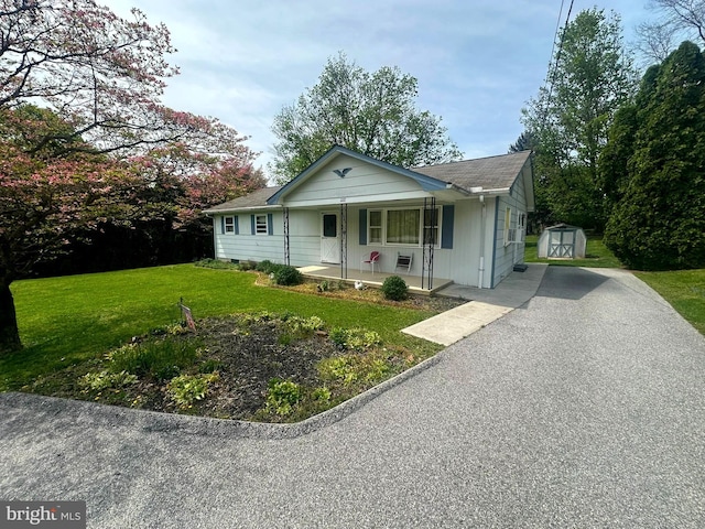 1222 Hoff Rd, Hanover, PA 17331 - bungalow featuring driveway, an outbuilding, covered porch, a front yard, and a storage shed