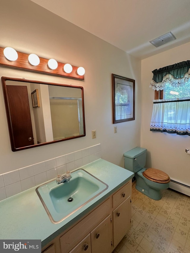 1222 Hoff Rd, Hanover, PA 17331 - bathroom featuring baseboard heating, visible vents, tile patterned floors, vanity, and backsplash