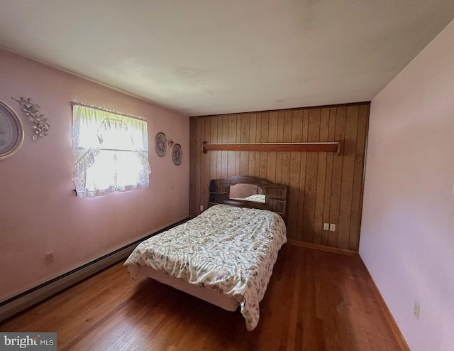 1222 Hoff Rd, Hanover, PA 17331 - bedroom with baseboards, wooden walls, and wood finished floors
