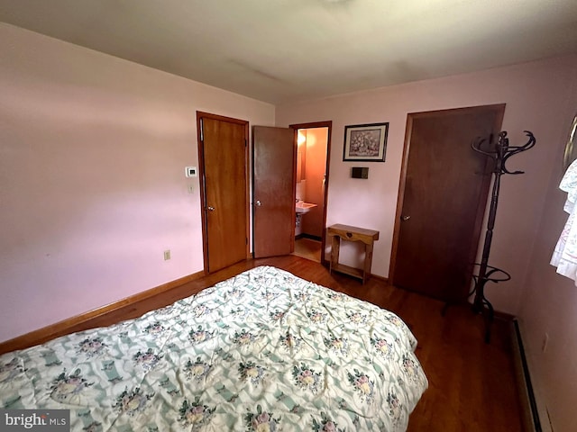 1222 Hoff Rd, Hanover, PA 17331 - bedroom with baseboards, baseboard heating, connected bathroom, and dark wood-style floors