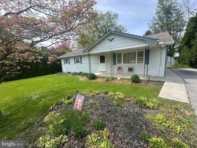 1222 Hoff Rd, Hanover, PA 17331 - view of front facade featuring covered porch, a shingled roof, and a front yard