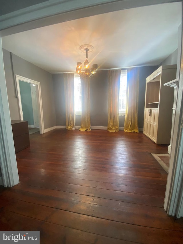 27 E Salisbury St, Williamsport, MD 21795 - empty room featuring a chandelier, healthy amount of natural light, and dark wood-type flooring