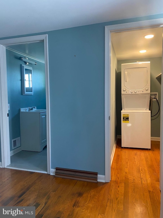 27 E Salisbury St, Williamsport, MD 21795 - hall featuring stacked washer and clothes dryer, light wood-style floors, and baseboards