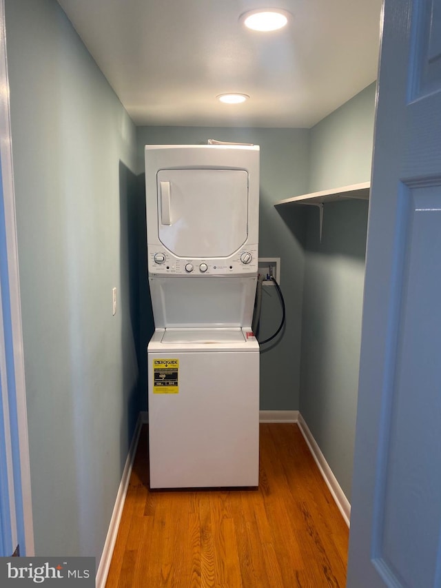 27 E Salisbury St, Williamsport, MD 21795 - laundry room featuring estacked washer and dryer, wood finished floors, and baseboards