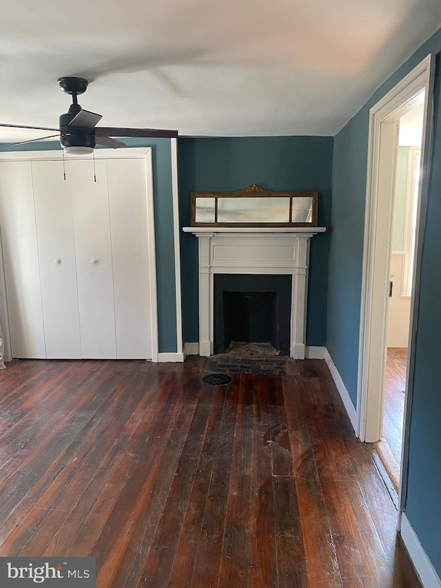 27 E Salisbury St, Williamsport, MD 21795 - unfurnished living room featuring wood-type flooring, ceiling fan, a fireplace, and baseboards