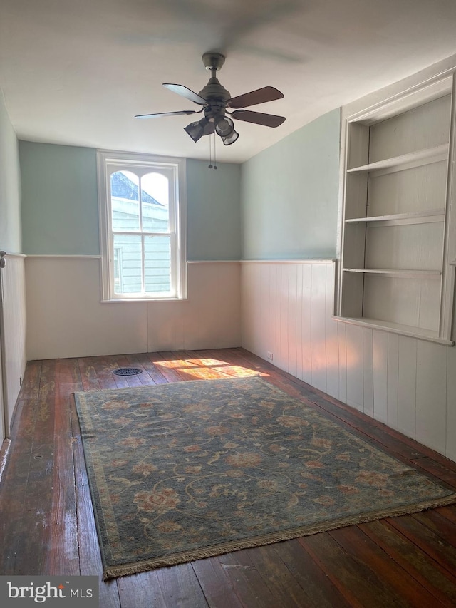27 E Salisbury St, Williamsport, MD 21795 - empty room featuring hardwood / wood-style flooring, a wainscoted wall, and a ceiling fan