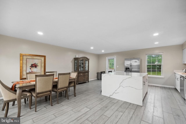 66 Vista Woods Rd, Stafford, VA 22556 - kitchen with stainless steel fridge, a center island, light wood-style floors, healthy amount of natural light, and recessed lighting