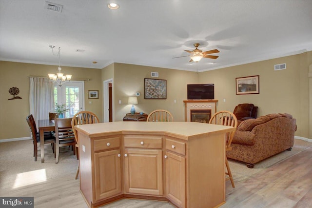 18 Lantern Ln, Shippensburg, PA 17257 - kitchen with a kitchen island, light wood finished floors, visible vents, and ceiling fan with notable chandelier