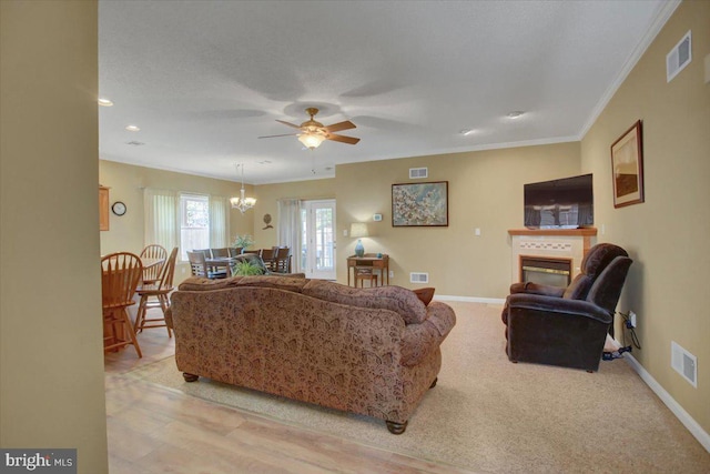 18 Lantern Ln, Shippensburg, PA 17257 - living room featuring ceiling fan with notable chandelier, a glass covered fireplace, baseboards, and visible vents