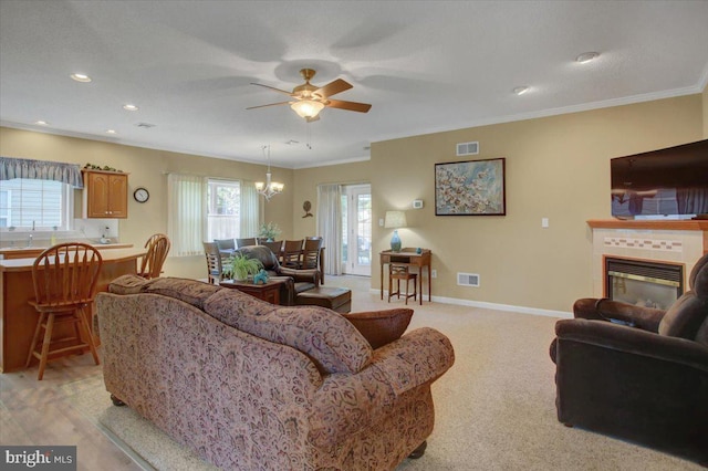 18 Lantern Ln, Shippensburg, PA 17257 - living room featuring ceiling fan with notable chandelier, visible vents, ornamental molding, and a healthy amount of sunlight