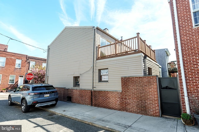view of side of property featuring brick siding