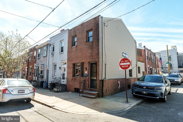 view of building exterior featuring a residential view and entry steps