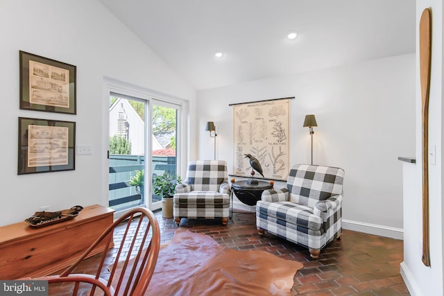 sitting room featuring baseboards, recessed lighting, brick floor, and vaulted ceiling